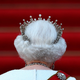 A photo of the back of the late Queen Elizabeth II walking up red stairs is shown.